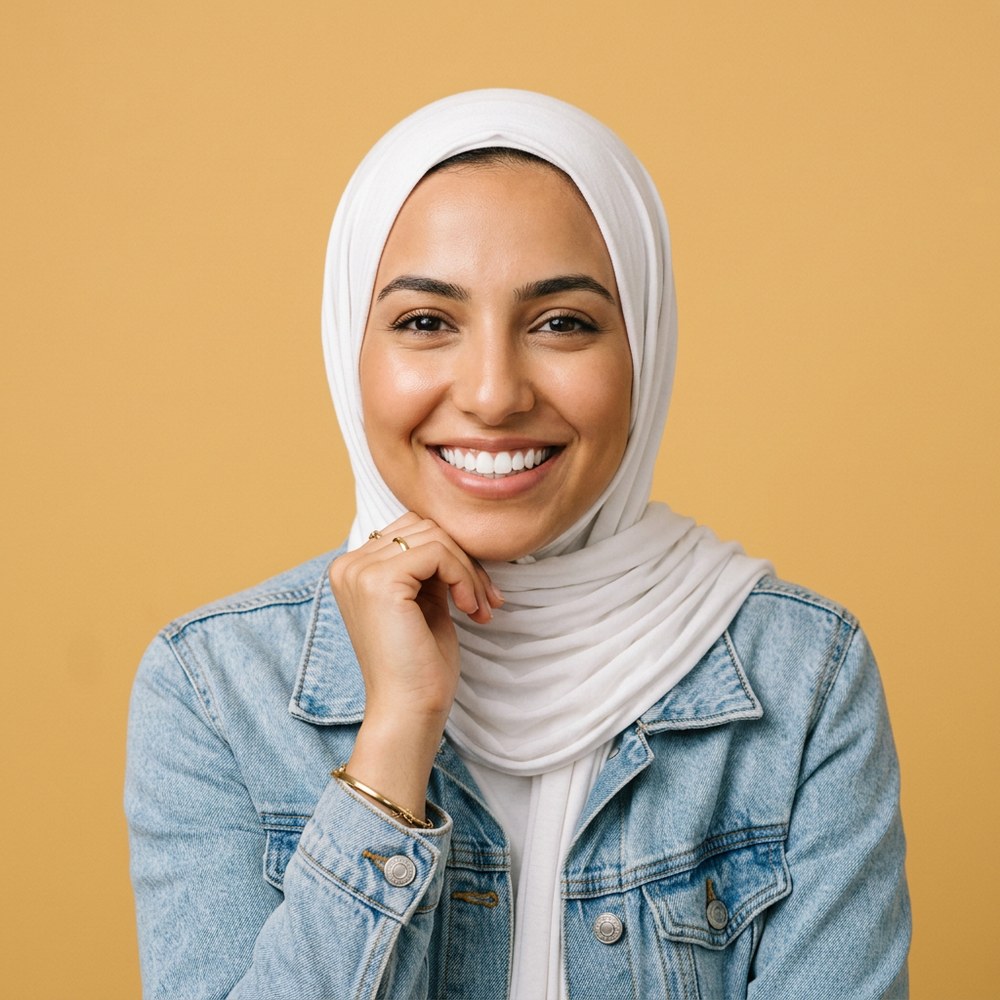 A smiling young woman in a white hijab