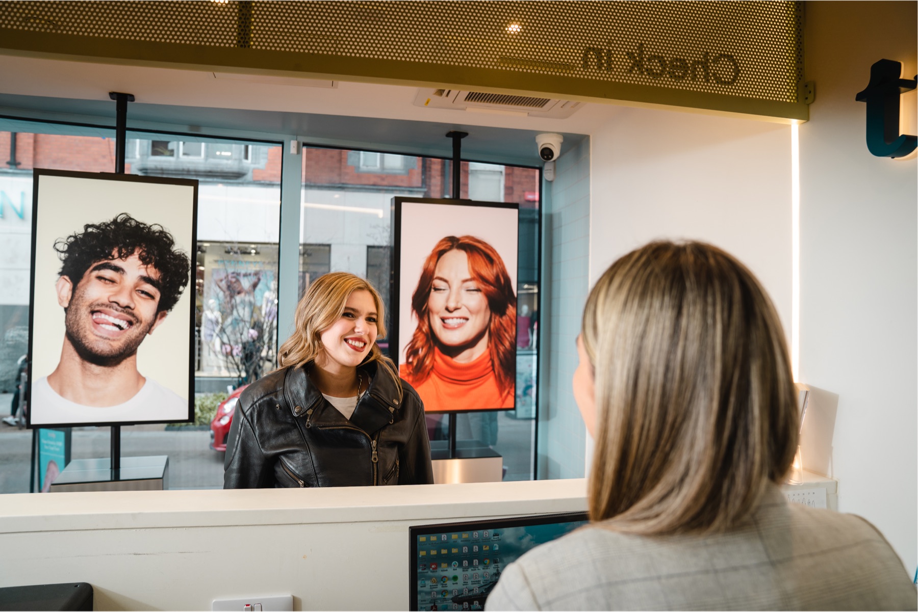 A patient smiling at the Truly check-in desk
