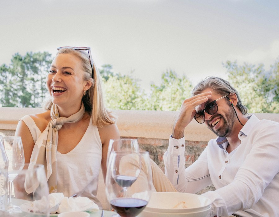 A mature couple laughing at the dinner table