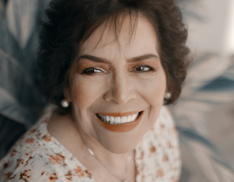 A mature woman with a warm, natural smile